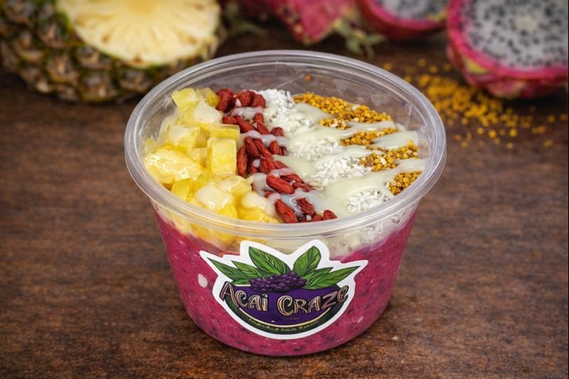 Pineapple Paradise Bowl: pink pitaya base with pineapple, goji berries, coconut, bee pollen and condensed milk